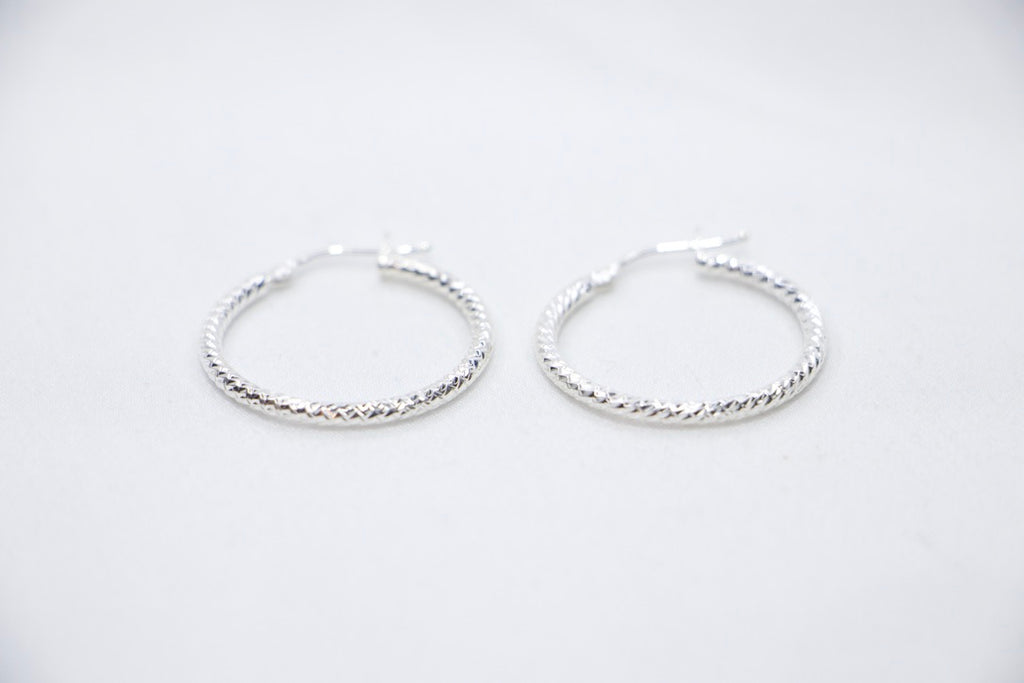 Sterling silver Woven Elegance Hoop Earrings featuring an intricate woven texture front views.